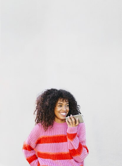 Woman holding her phone and smiling.